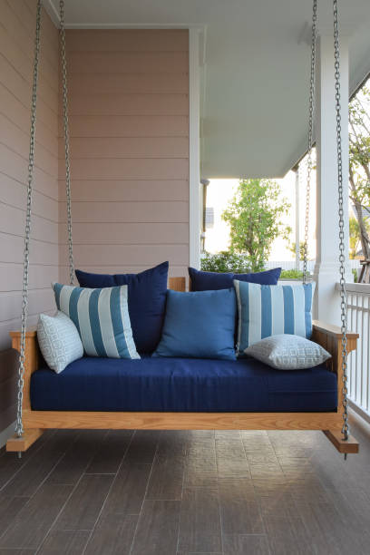 istock vintage wooden swing with blue pillows at home 683287994