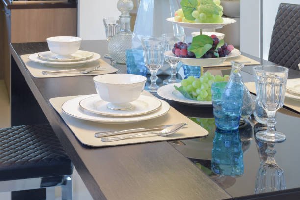 istock Chinaware setting on dining table with light blue crystal glass and fruits 683296648