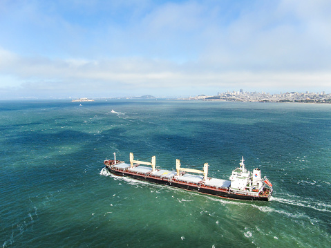 San Francisco: Aerial view of cargo ship and cityscape or skyline in bay