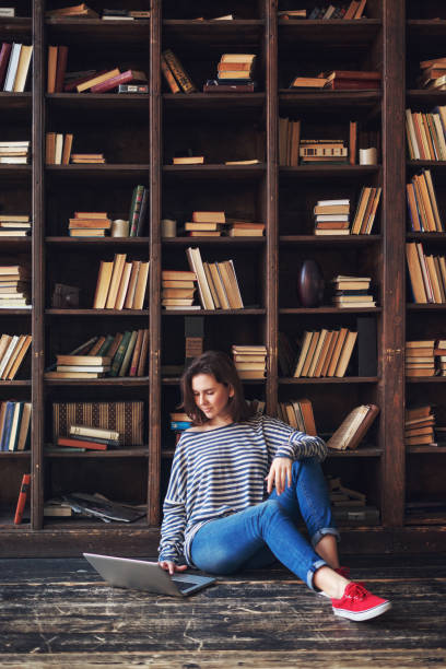 istock Young woman studying in the library 683300776