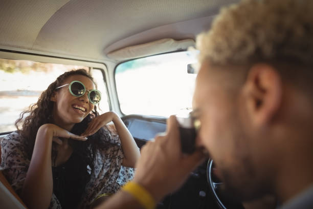 istock Man photographing woman in van 683300878