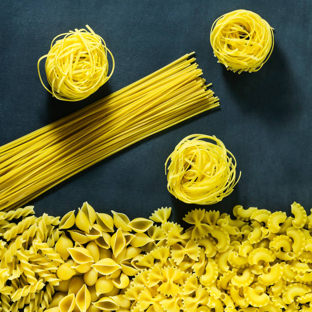 istock Different types of dry Italian pasta on a dark blue background. 683307462