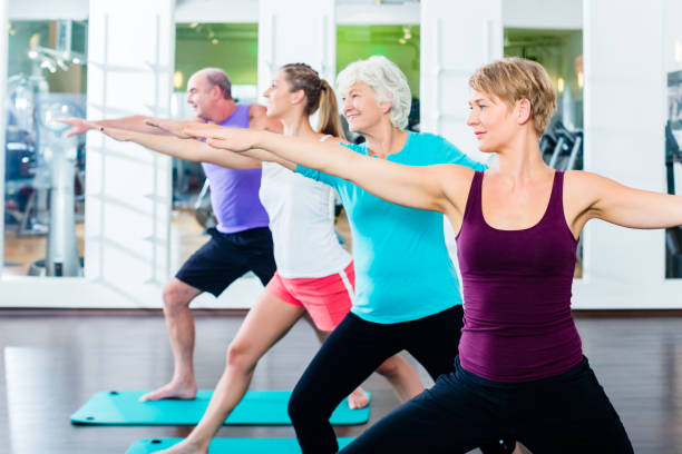 istock Senior and young people doing gymnastics in gym 683309760