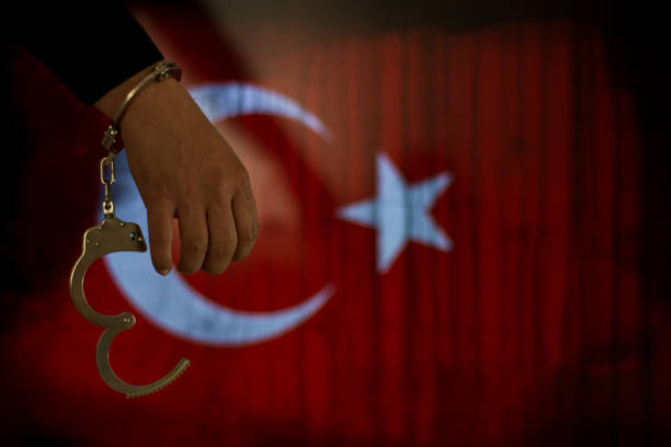 Handcuffs with hand in front of flag