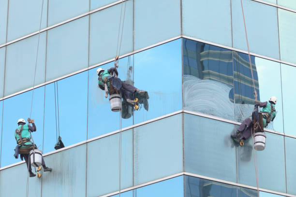 istock group of workers cleaning windows service on high rise building 683316838