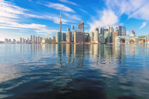 The Rogers Centre Hockey stadium, the CN Tower Toronto skyscraper high building, and the skyline. Ontario Lake, Ontario, Canada