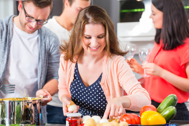 istock Friends cooking pasta and meat in domestic kitchen 683326522