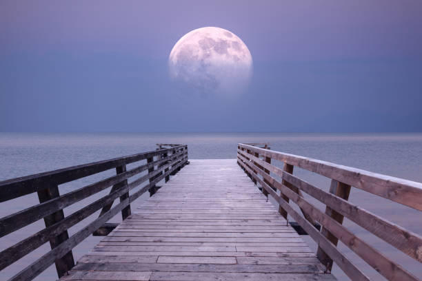 istock Full moon and viewpoint platform at sea dusk 683329506