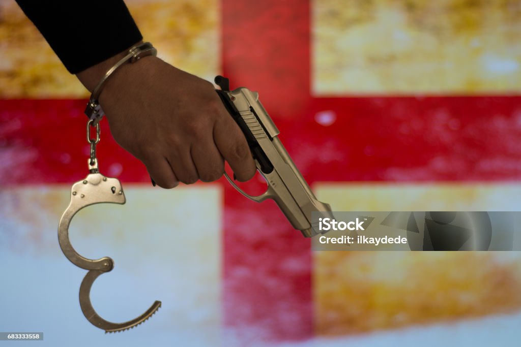 Crime and justice concept with handgun Chain - Object Stock Photo