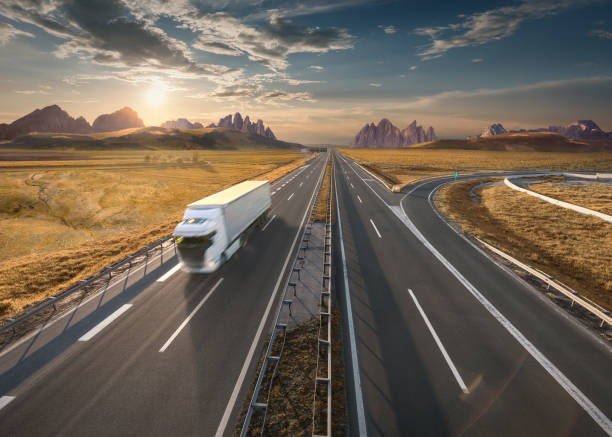 istock Single white truck on highway at idyllic sunset 683333672