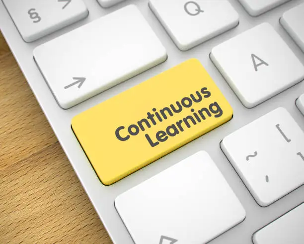 Photo of Continuous Learning - Message on Yellow Keyboard Key. 3D
