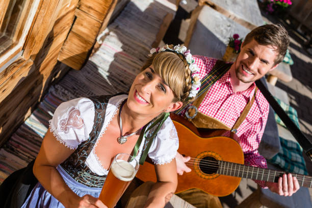 Couple on mountain hut making guitar music