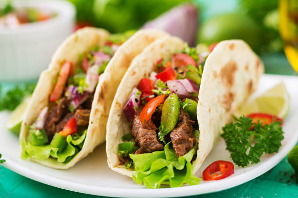 istock Mexican tacos with beef in tomato sauce and salsa 683340340