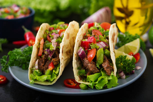 istock Mexican tacos with beef in tomato sauce and salsa 683340348