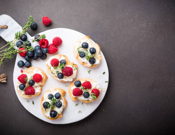istock Cup of coffee with fruit sandwiches 683342530