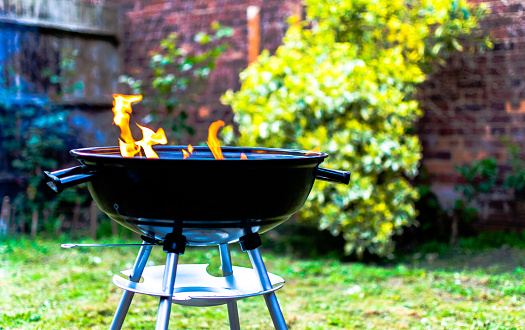Flames from a grill in preparation for a family bbq
