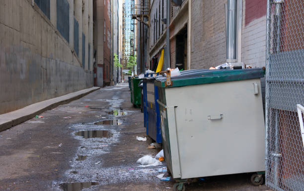 istock Dirty filthy back alley with dumpsters and garbage trash 683370120