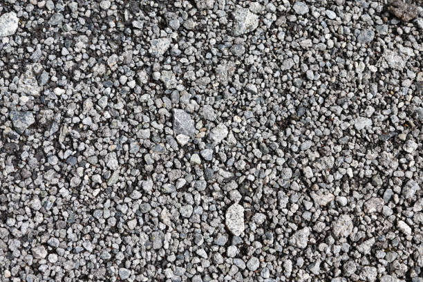 Texture of gray gravel Texture of gray gravel. Grey stony floor. A wall of gray gravel. Stones small and medium-sized. Sharp edges of the stones. Sand and stones on the floor. The land is covered with stones. hard bituminous coal stock pictures, royalty-free photos & images