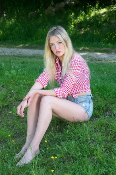 Young blonde woman in park. Cute teenage girl outdoors. Mild retouch, vibrant colors. Young blonde woman in park. Cute teenage girl outdoors. Mild retouch, vibrant colors. human body lice stock pictures, royalty-free photos & images