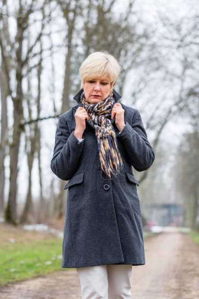 istock Depressed or sad woman walking in winter 683382226