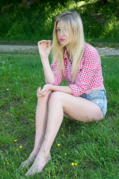 Young blonde woman in park. Cute teenage girl outdoors. Mild retouch, vibrant colors. Young blonde woman in park. Cute teenage girl outdoors. Mild retouch, vibrant colors. human body lice stock pictures, royalty-free photos & images