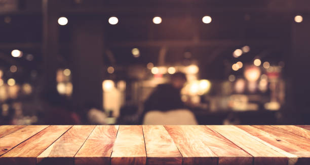 Wood table with blur light in night cafe,restaurant background