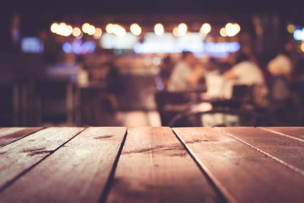 Wood table with blur light in night cafe,restaurant background