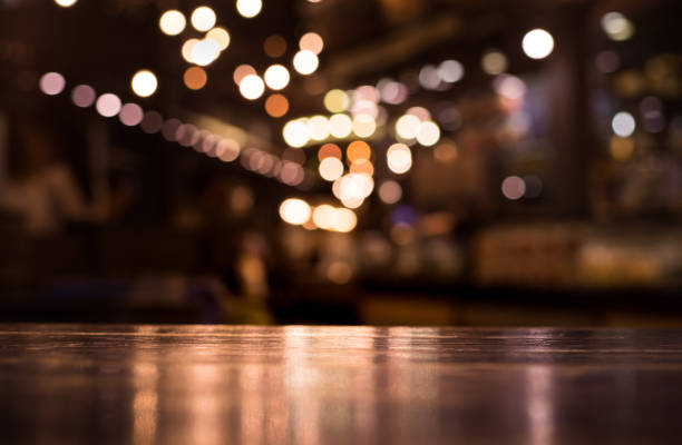 istock Wood table with blur light in night cafe,restaurant background 683388618