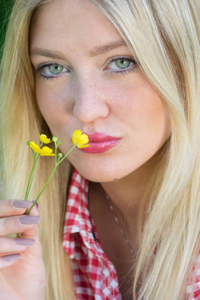Spring girl. Lovely blond girl with flowers Beautiful sunny portrait of a blond girl with young blue eyesSpring girl. Lovely blond girl with flowers human body lice stock pictures, royalty-free photos & images
