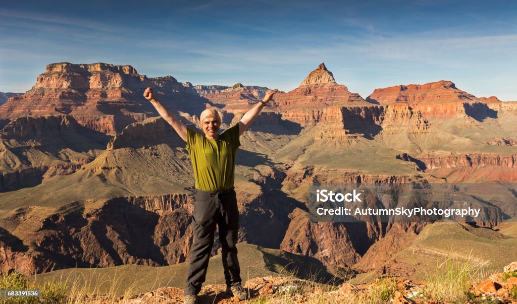 Happy Hiker enjoying views on Horseshoe Mesa, Grand Canyon of Arizona Picture taken at end of Hiking Trail descending from Grandeview Point on South Rim.  Vishnu Temple on North Rim can be seen benind Arizona Stock Photo