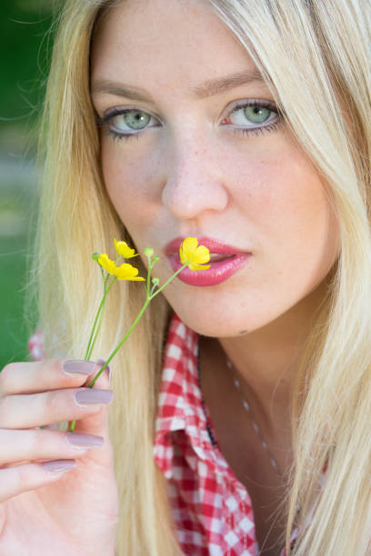 Spring girl. Lovely blond girl with flowers Beautiful sunny portrait of a blond girl with young blue eyesSpring girl. Lovely blond girl with flowers human body lice stock pictures, royalty-free photos & images