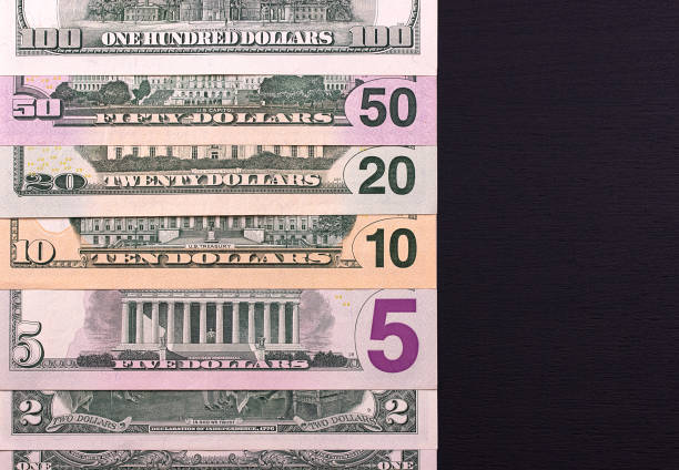 istock Pile of dollar bills of different denominations on black backgrond. 683392032