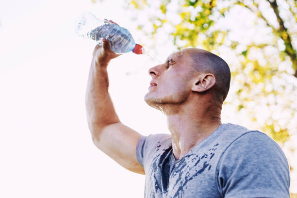 istock young athlete is refreshing himself with water, sport and healthy lifestyle 683402148