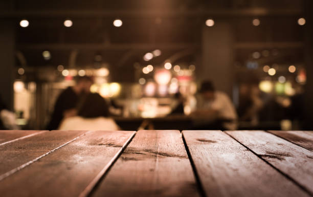 istock Wood table with blur light in night cafe,restaurant background 683405702