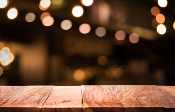 istock Wood table with blur light in night cafe,restaurant background 683406118