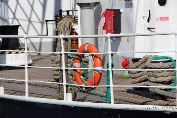 Red lifebuoy and whithe boat's rail of an old sailboat