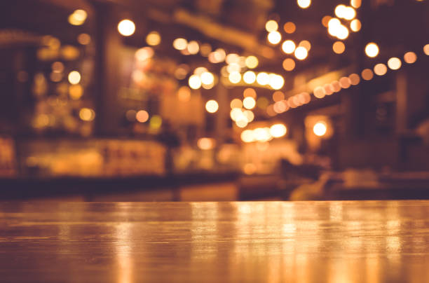 istock Wood table with blur light in night cafe,restaurant background 683410662