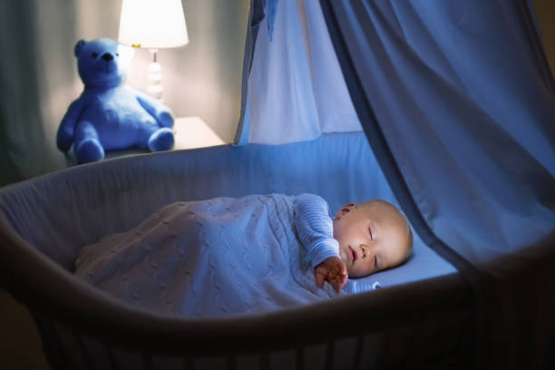 istock Baby boy drinking milk in bed 683410824