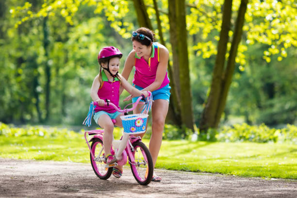 istock Mother teaching child to ride a bike 683411326