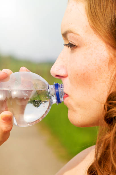 istock Young woman drinking water 683411910