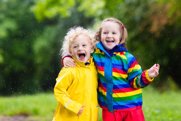 istock Kids play in rain and puddle in autumn 683412234