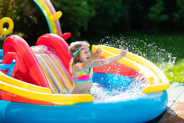 istock Child in garden swimming pool with slide 683412494