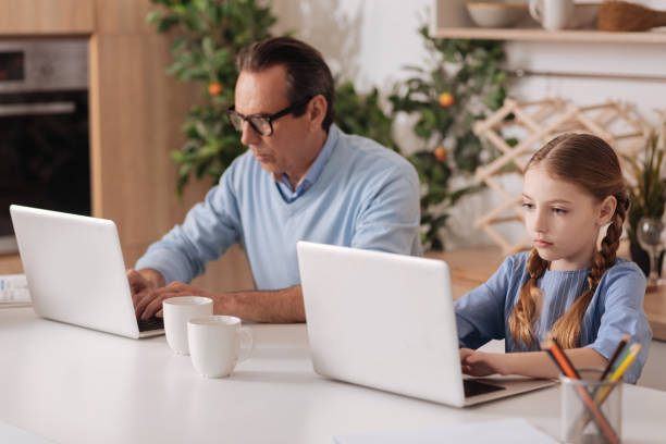 istock Ignorant grandfather and little girl using laptops indoors 683412664