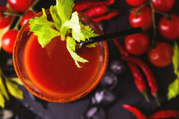 Bloody Mary cocktail with chili pepper, ice and celery. Bloody Mary cocktail with spicy smoked ground chili pepper, ice and celery. vodka sauce stock pictures, royalty-free photos & images