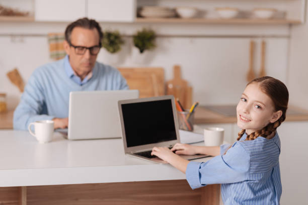 istock Cheerful little girl and mature man using modern gadgets indoors 683414864