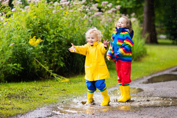istock Kids play in rain and puddle in autumn 683415290