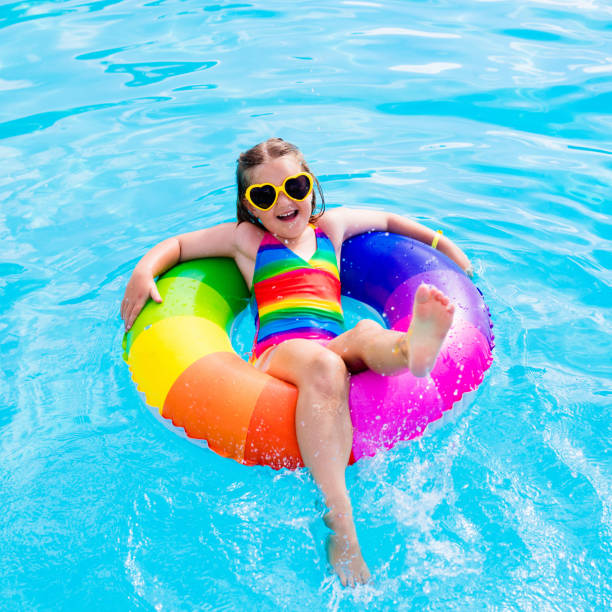 istock Child with toy ring in swimming pool 683415470