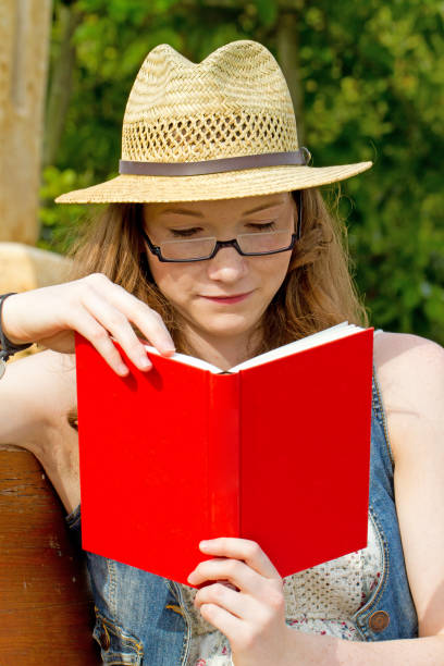 istock Youg woman reading a book 683415488