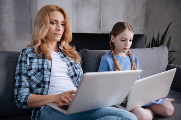istock Addicted parent and little kid using laptops indoors 683415498