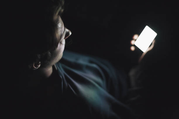 istock Teenage boy using smart phone in the dark 683423806